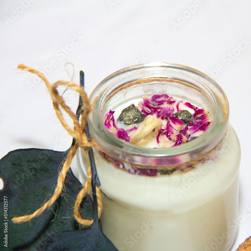 scented candles in glass jar with decorative elements