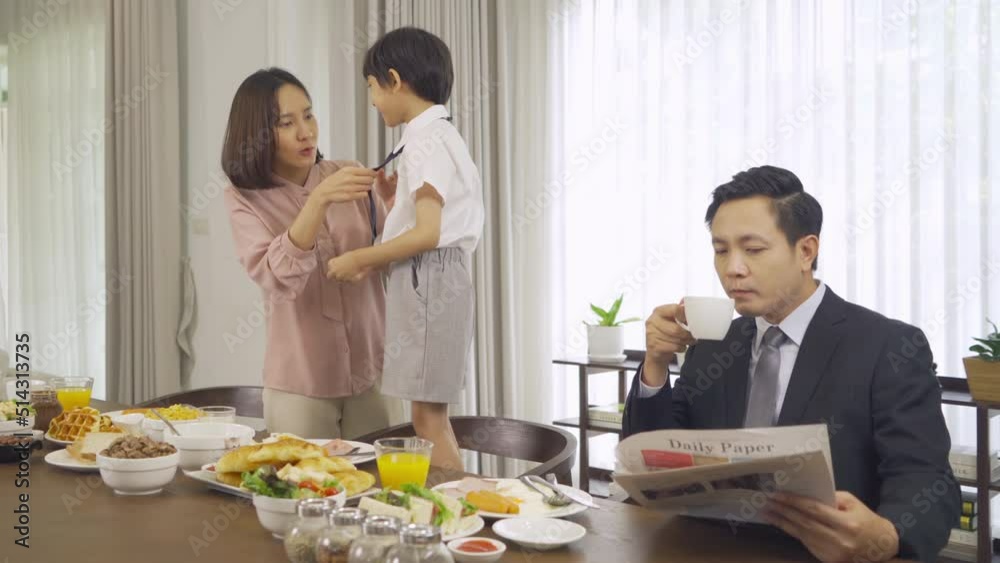 Portrait of happy smiling Asian Family eating breakfast food together before the child going to school at home. Family relationship. Love of father, mother, and son. People lifestyle. Business man. Portrait of happy smiling Asian Family eating breakfast food together before the child going to school at home. Family relationship. Love of father, mother, and son. People lifestyle. Business man.