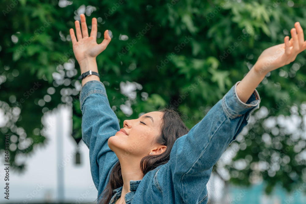 relaxed girl breathing calmly in the open air with her arms raised relaxed girl breathing calmly in the open air with her arms raised