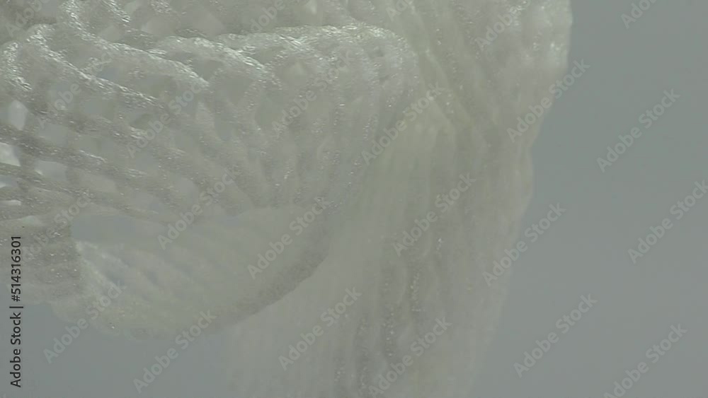 white foam basket. white foam net for fruit wrapping. roll up mesh foam container for apples, pears, vegetables, eggs and more on a white background