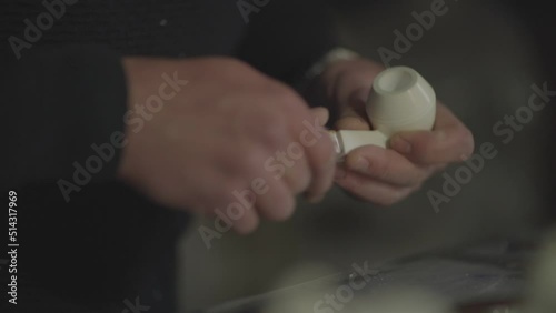 Close-up shot of man making handmade meerschaum pipe