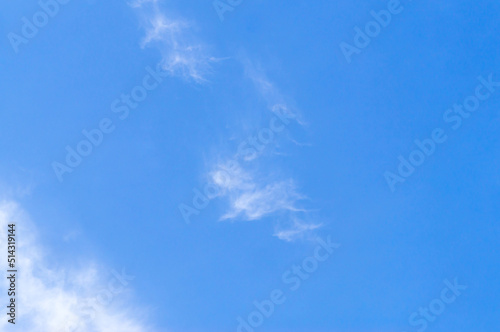 Beautiful blue sky texture with little strange white cloud and clear light under shining from the sun for background