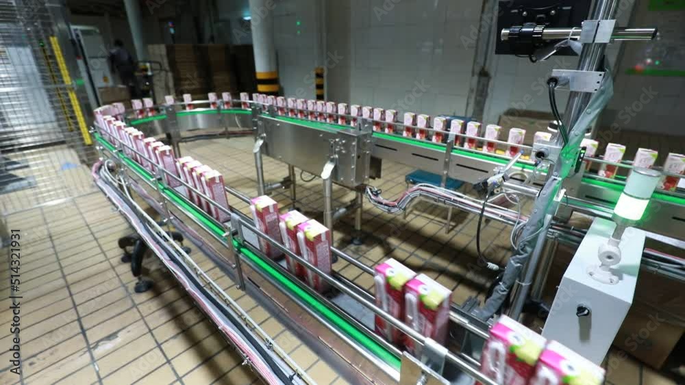 Workers work hard on the dairy production line in Mengniu Dairy Co., Ltd, North China Workers work hard on the dairy production line in Mengniu Dairy Co., Ltd, North China