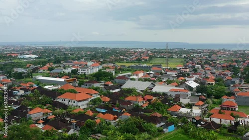 local residential houses with orange roofs in canggu bali at sunset, aerial photo