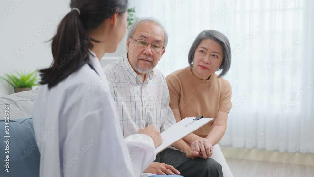 Asian caregiver nurse examine senior male patient and his wife at home Asian caregiver nurse examine senior male patient and his wife at home