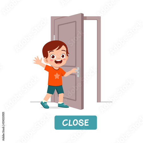 little kid standing and holding door knob