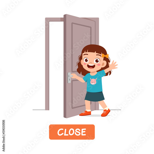little kid standing and holding door knob