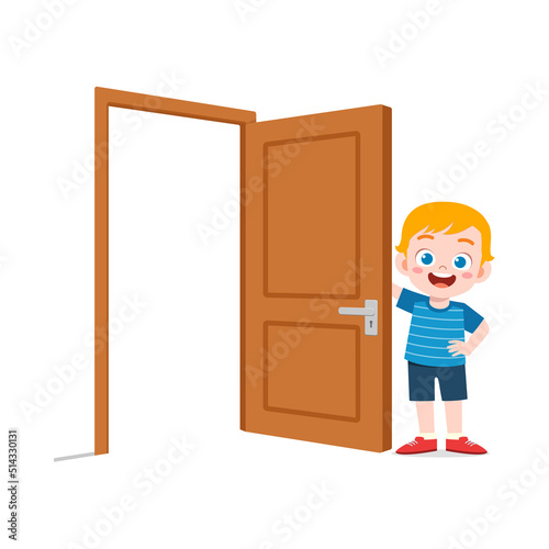 little kid standing and holding door knob