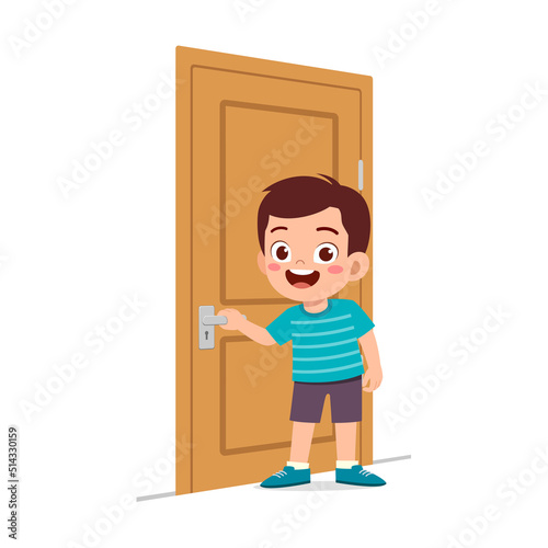 little kid standing and holding door knob