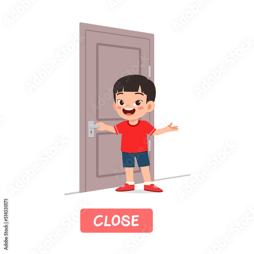 little kid standing and holding door knob