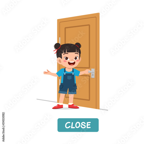 little kid standing and holding door knob