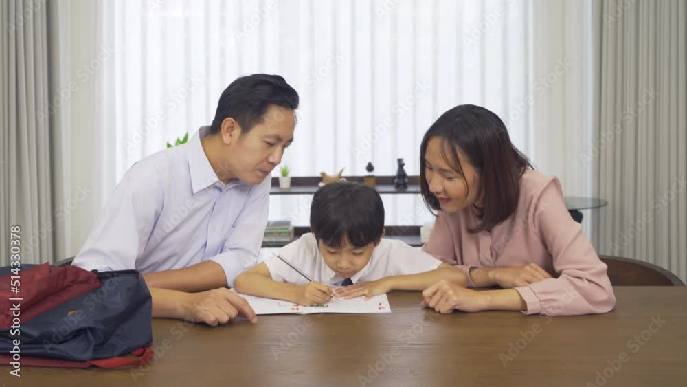 Portrait of happy smiling Asian Family. A student studying homework from school at home or house in family relationship. Love of father, mother, and son. People lifestyle. Education activity. Portrait of happy smiling Asian Family. A student studying homework from school at home or house in family relationship. Love of father, mother, and son. People lifestyle. Education activity.