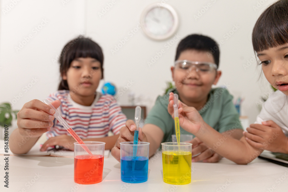 Asian kids do chemical experiments in their home Asian kids do chemical experiments in their home