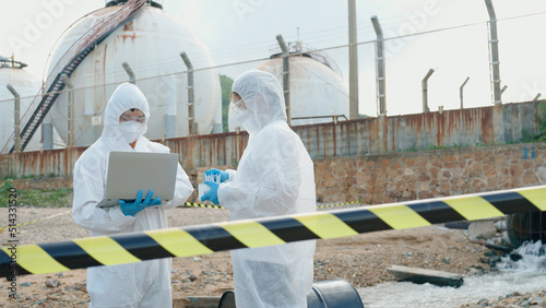 Professional laboratory workers testing water from a factory. photo