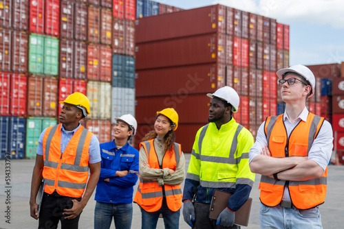 Group of engineer worker and manager standing in the shipping yard container.