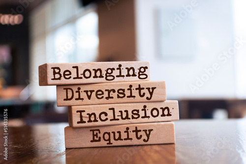 Equity, diversity, inclusion and belonging symbol. Wooden blocks with words 'equity, diversity, inclusion, belonging' on brown background. Diversity, equity, inclusion and belonging concept.