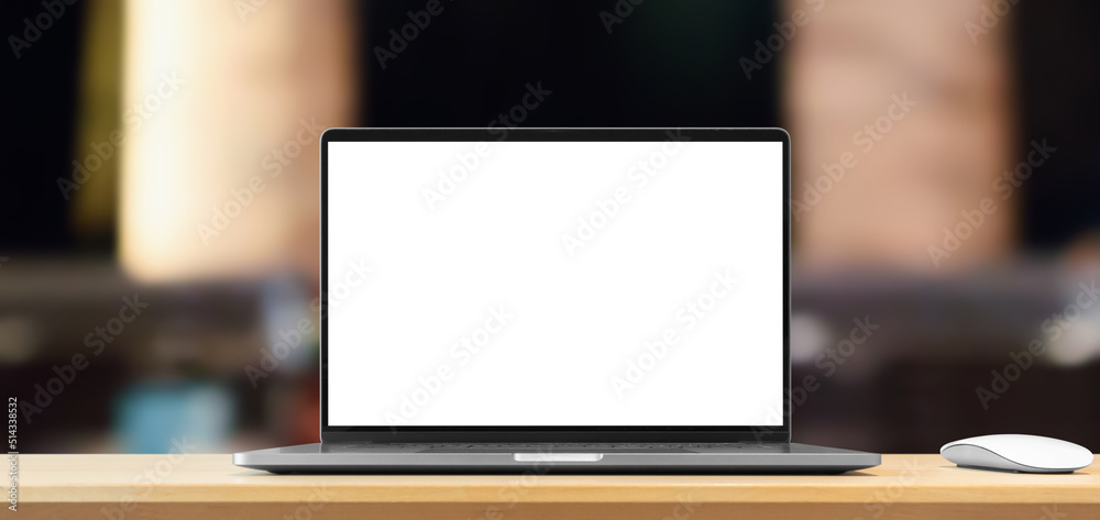 Laptop with blank screen on wood table with cafe coffee shop blur background Laptop with blank screen on wood table with cafe coffee shop blur background