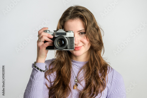 Taking picture young pretty woman with noze ring. Retro camera. Smiling long hair noze ring head-on portrait