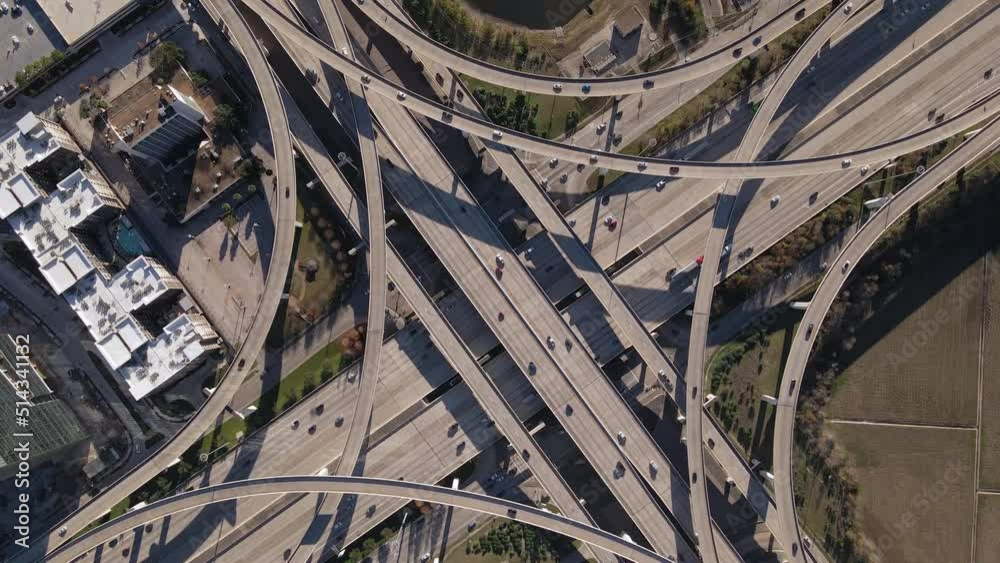 Top-down aerial view of Interstate I-10 freeway and Bellway 8 Houston Texas. Rotating Bird Eyes shot of the intersection at I-10 west and Sam Houston Tollway in Houston Texas. Counter-clockwise rotate Top-down aerial view of Interstate I-10 freeway and Bellway 8 Houston Texas. Rotating Bird Eyes shot of the intersection at I-10 west and Sam Houston Tollway in Houston Texas. Counter-clockwise rotate