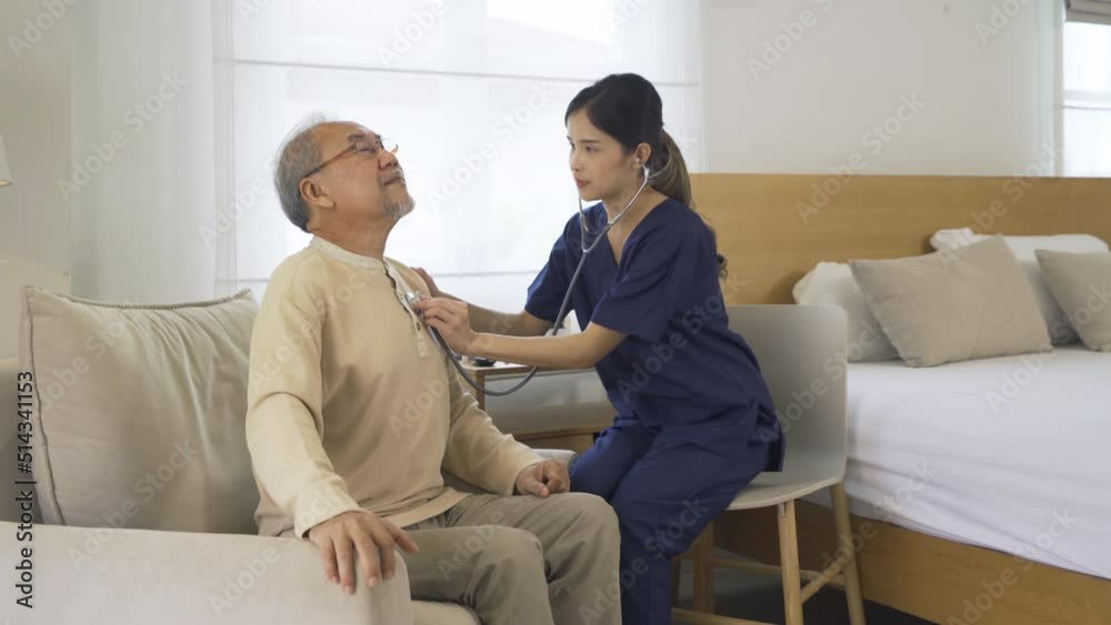 Happy woman nurse, daughter check up body of sick old senior elderly patient lying on bed in bedroom in home or house in medical and healthcare treatment. Asian Thai people lifestyle. Family Happy woman nurse, daughter check up body of sick old senior elderly patient lying on bed in bedroom in home or house in medical and healthcare treatment. Asian Thai people lifestyle. Family