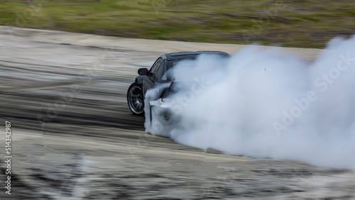 Race car drifting on speed track, Professional driver drifting car on race track with smoke, Abstract texture and background black tire tracks skid on asphalt road, Wheel tire tracks background.
