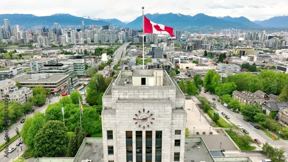 Drone Rises Above Vancouver City Hall With Waving Flag In Vancouver, British Columbia, Canada. Aerial Shot