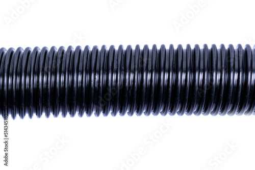 Flexible corrugated hose from a vacuum cleaner insulated on a white background