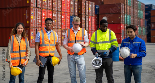 Group of engineer worker and manager standing in the shipping yard container.