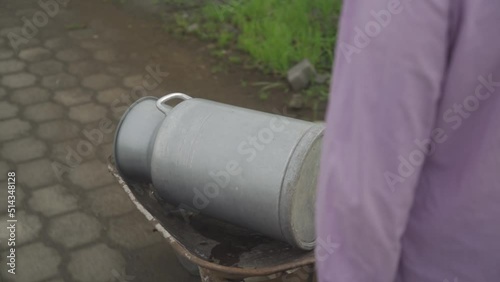 Wallpaper Mural Worker carrying buckets of milk and walking in rural. Milkmaid. Dairy products Torontodigital.ca