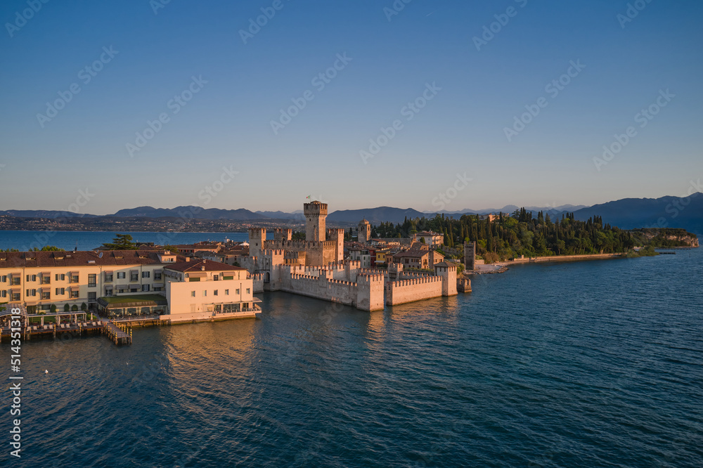 Fototapeta premium Aerial view of Scaligero Castle at sunrise. Sirmione on Lake Garda, Italy.