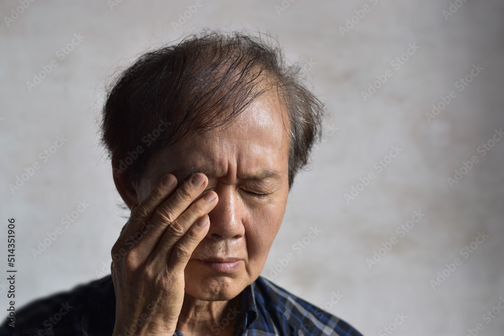 Asian man rubbing his eye. Concept of eye strain or itchy eyelid. Asian man rubbing his eye. Concept of eye strain or itchy eyelid.