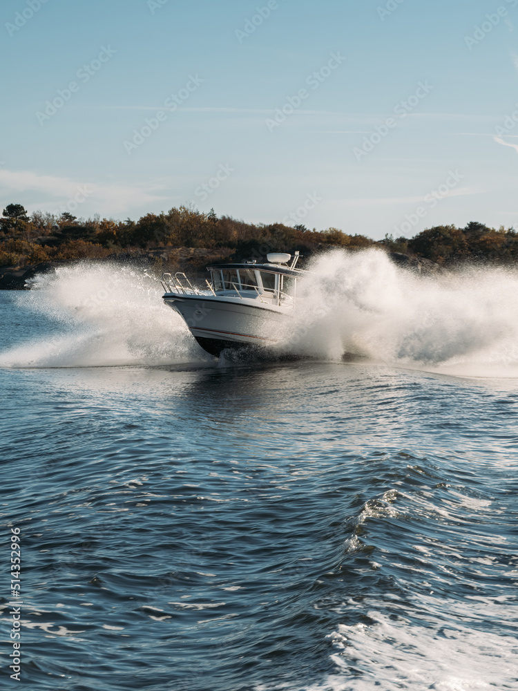 Fototapeta premium Speedboat in navigation goes on the waves in deep blue water, sea view.