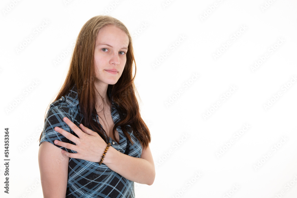serious young woman with her hand on her shoulder in front of a copy space serious young woman with her hand on her shoulder in front of a copy space