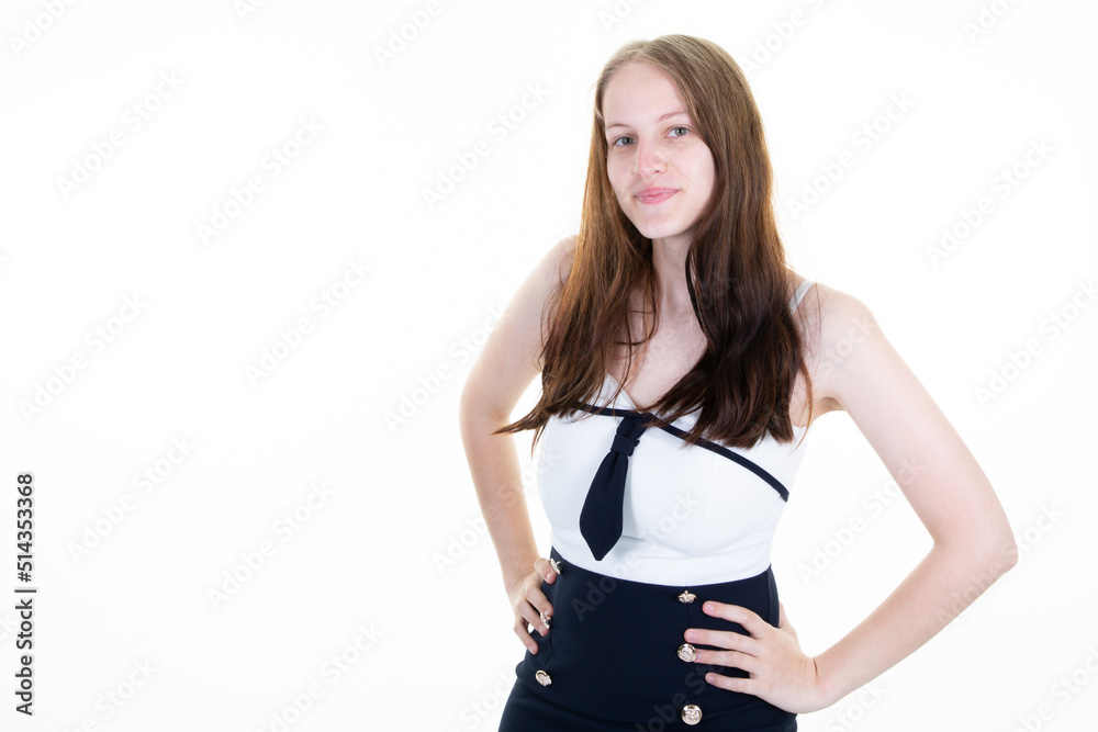 young woman portrait in white businesswoman dress hands on hips with her long blond hair in front of a light background young woman portrait in white businesswoman dress hands on hips with her long blond hair in front of a light background