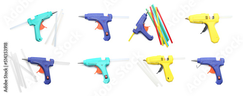 Set with different glue guns with sticks on white background, top view. Banner design