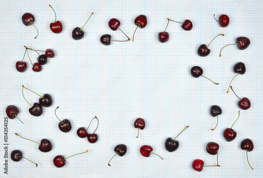 Frame from ripe fresh dark red cherries on millimeter texture paper background. Desert healthy berry summer food concept. Top view ,flat lay. Free copy space. Frame from ripe fresh dark red cherries on millimeter texture paper background. Desert healthy berry summer food concept. Top view ,flat lay. Free copy space.