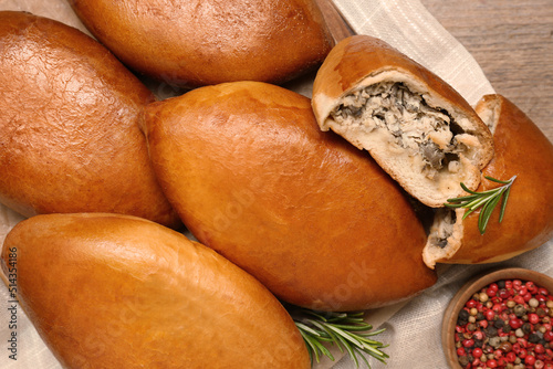 Many delicious baked patties on table, flat lay photo