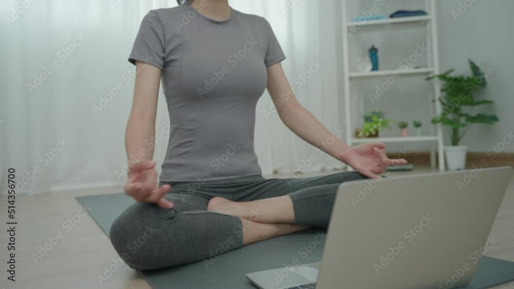 woman watching video yoga on internet by laptop at home. Women play yoga for strengthen the abdomen and to lose weight and recreation. Healthy and recreation concept. woman watching video yoga on internet by laptop at home. Women play yoga for strengthen the abdomen and to lose weight and recreation. Healthy and recreation concept.