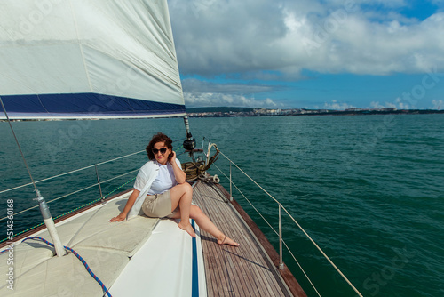 woman tourist traveler in sunglasses on a summer day on a yacht in the sea © Daria