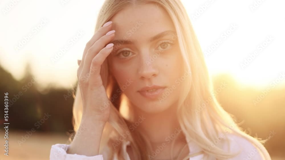 Portrait of beautiful blond woman with long hair. Sunny face of gorgeous girl looking to camera. Portrait of beautiful blond woman with long hair. Sunny face of gorgeous girl looking to camera.