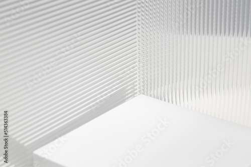 Stripe texture acrylic sheet. Clear linear prismatic panel, extruded linear ribs acrylic sheet. Abstract minimal graphic design resource. Close up of clear transparent plexiglass.