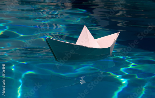 Origami paper ship. Paper boat in blue sea background. Tourism, travel dreams vacation holiday. © Volodymyr