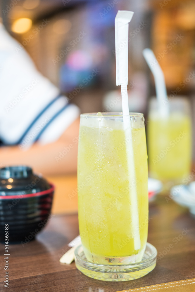 Iced green tea in tall glass with straw served for customer at Japanese restaurant. Iced green tea in tall glass with straw served for customer at Japanese restaurant.