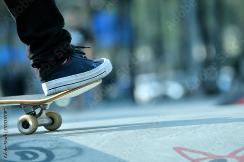 Close-up of young hipster man skateboarding in the Chinese city