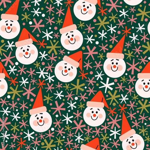 Seamless vector pattern with cute colorful snowmen in red hats and colorful snowflakes. Bright red, white, green winter pattern. Winter festive background for print, wrapping paper, textile, etc.