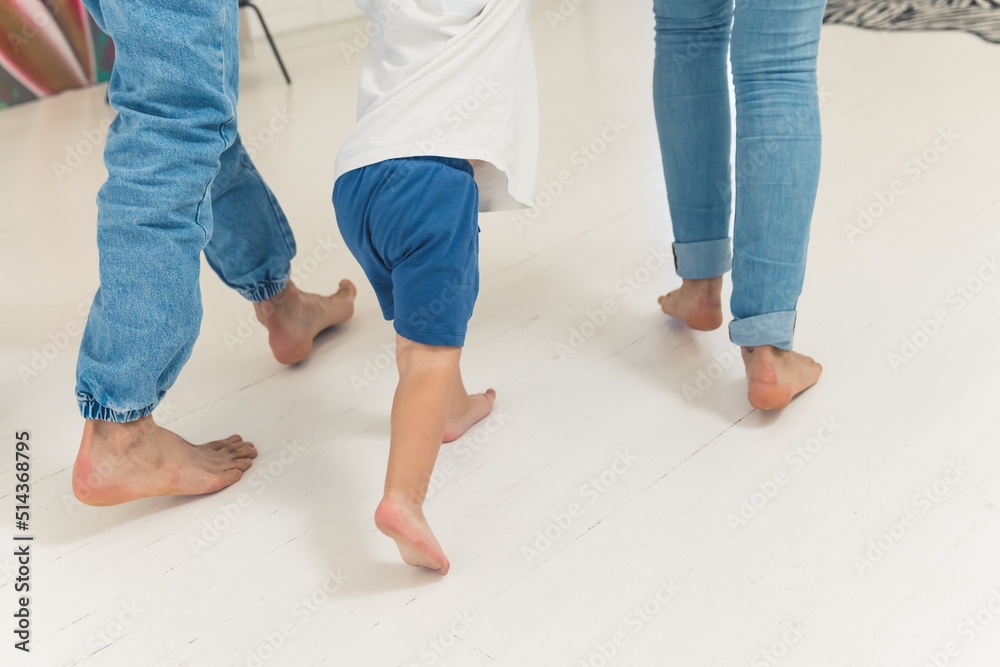 little boy walking with his parents in the kitchen family concept. High quality photo