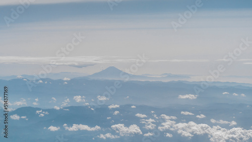 View of famous Japanese mountain Fuji  with cloudy sky ,taken from airplane window © Waranyu