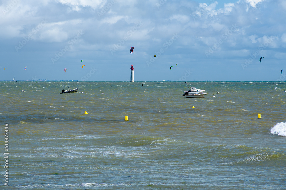 Viewe from plage de Notre dame at Saint-Marie-de-Re on the Anse Notre Dame at high tide with boats and kite surfers