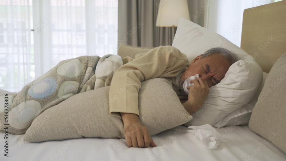 Old elderly senior man. Sick Asian person coughing in medical treatment and health care on bed in bedroom at home or house. covid-19 or Coronavirus. People lifestyle in quarantine. Old elderly senior man. Sick Asian person coughing in medical treatment and health care on bed in bedroom at home or house. covid-19 or Coronavirus. People lifestyle in quarantine.