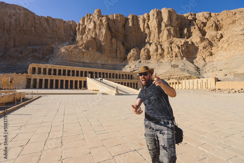 White Man Tourist visiting an Ancient Mortuary Temple of Hatshepsut near Luxor, Egypt photo